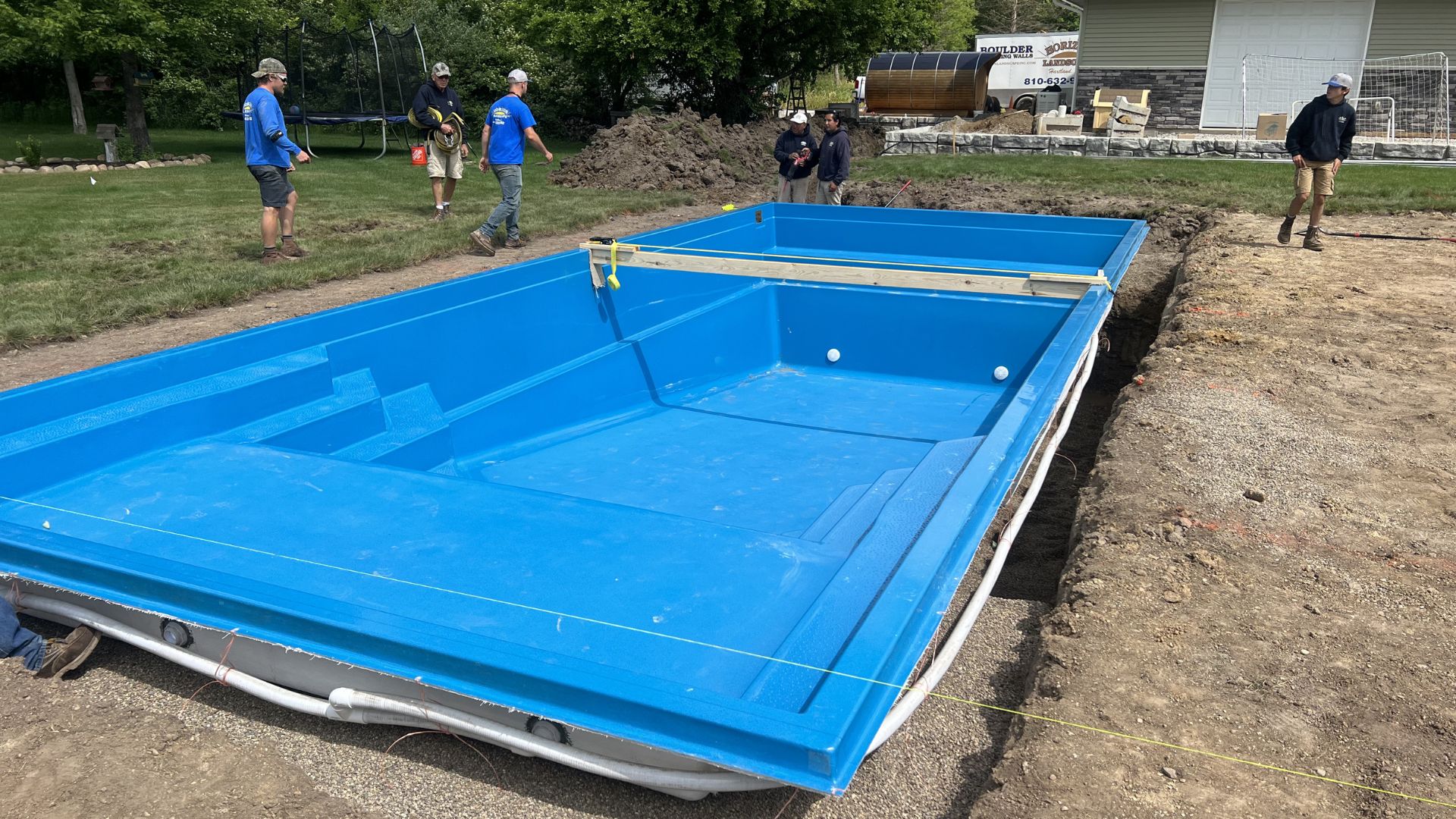 workers installing an inground pool